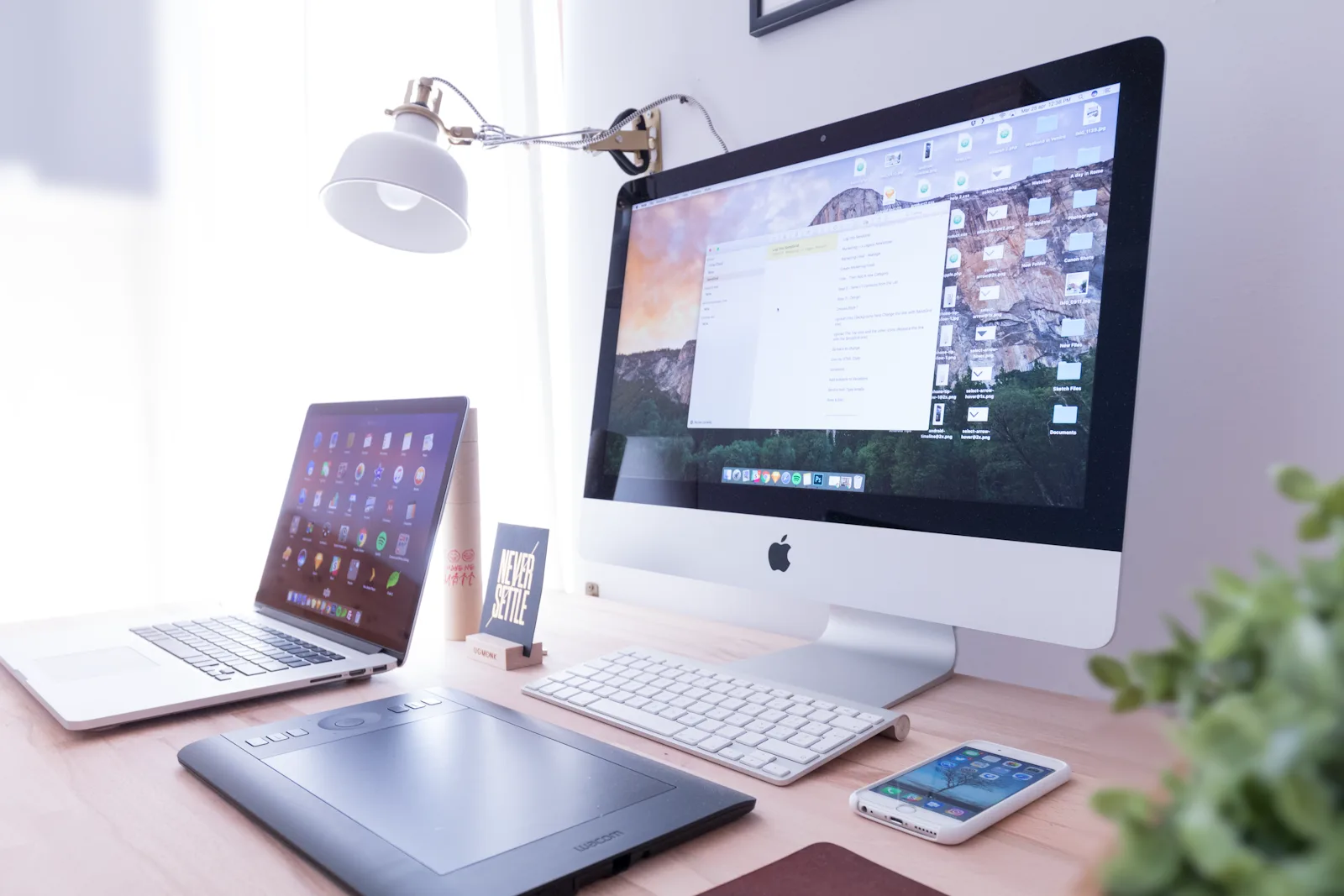 Silver Apple iMac and iPhone on a clean desk representing Apple Intelligence interface design