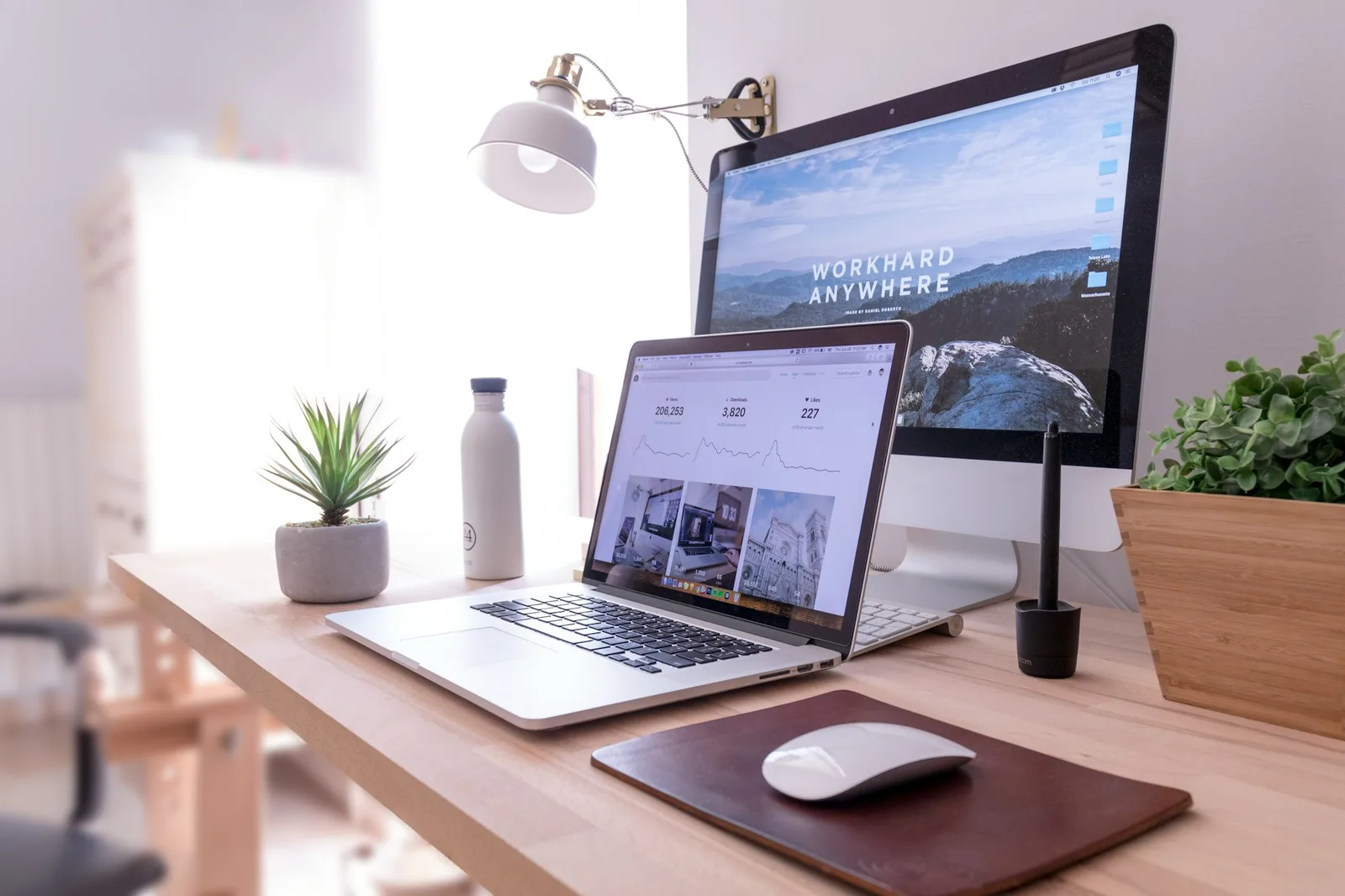 MacBook Pro and iMac on a desk showing an online store interface layout