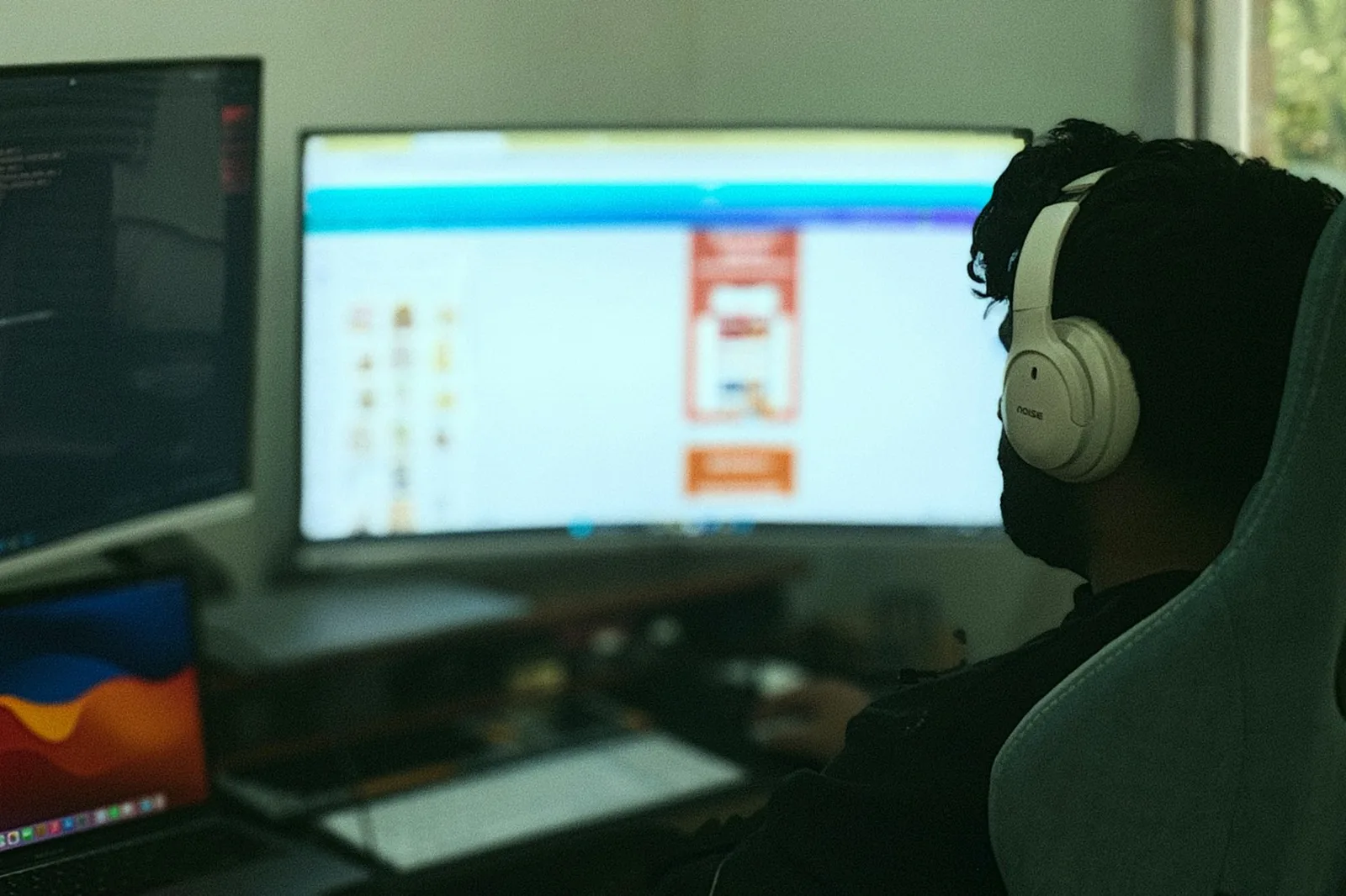 Multiple computer monitors on a desk showing an interface at different sizes side by side