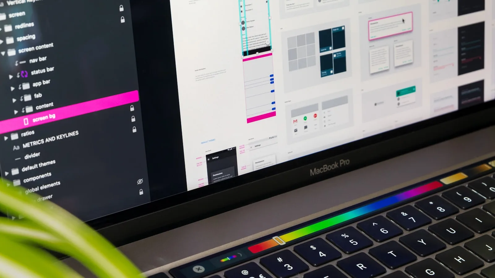 Colorful design tool interface glowing on a monitor in a dark studio workspace