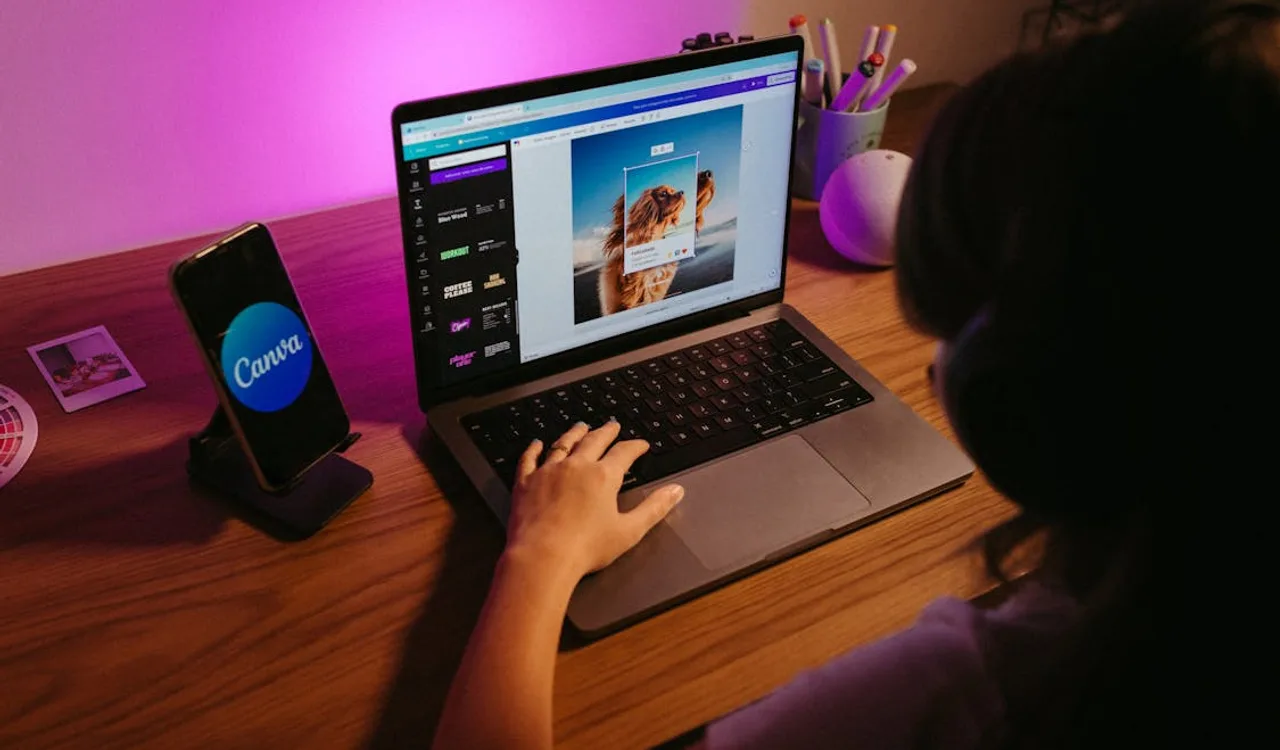 Person at laptop comparing Figma vs Canva design tool interfaces displayed side by side on screen