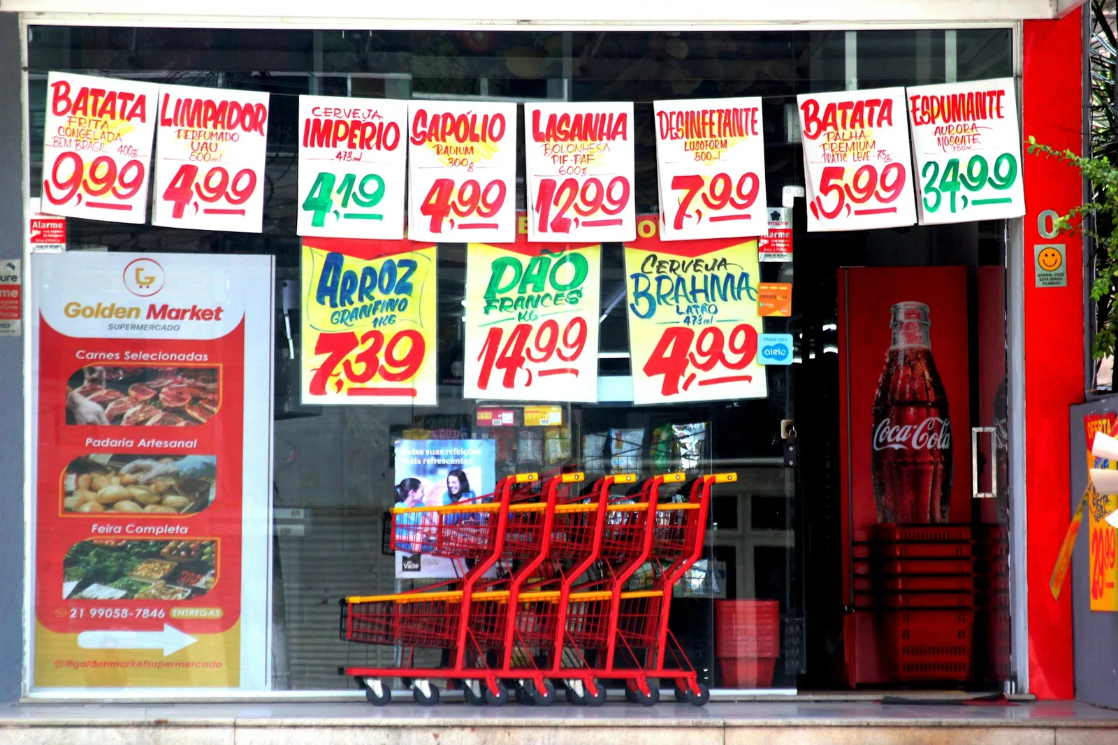 Grocery store window displaying rows of price tags