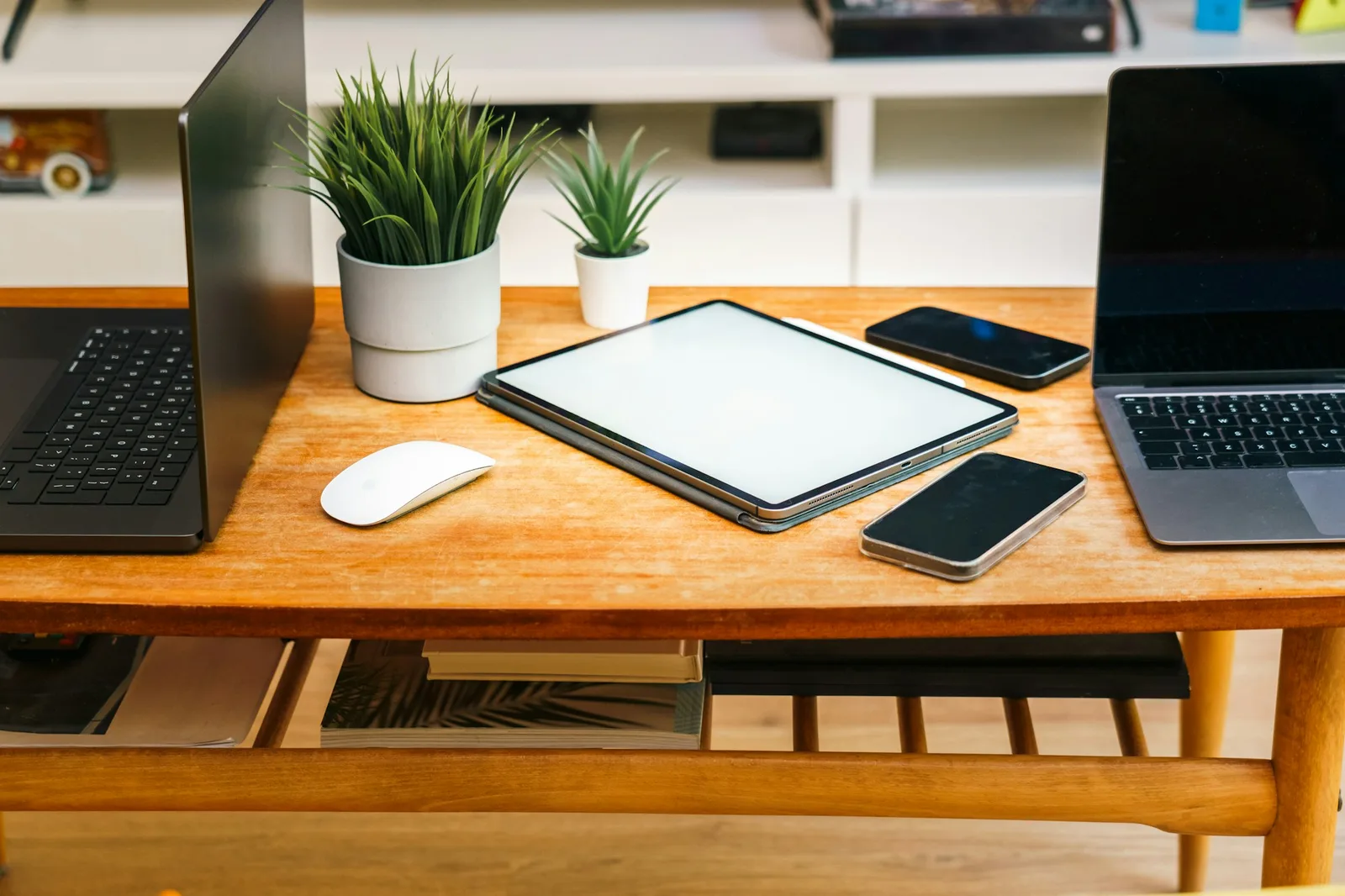Laptop, tablet, and phone arranged on a desk showing the range of screen sizes a responsive layout must support