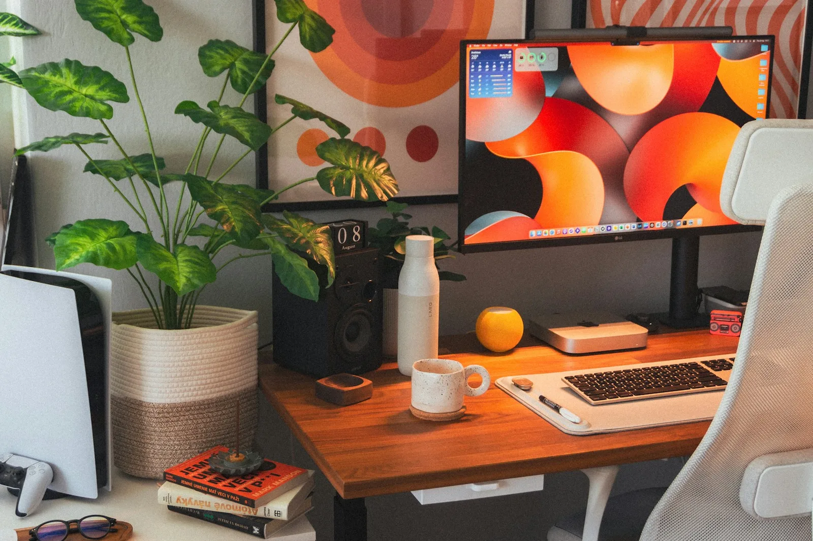 Desk with a laptop computer and a potted plant in a freelance workspace