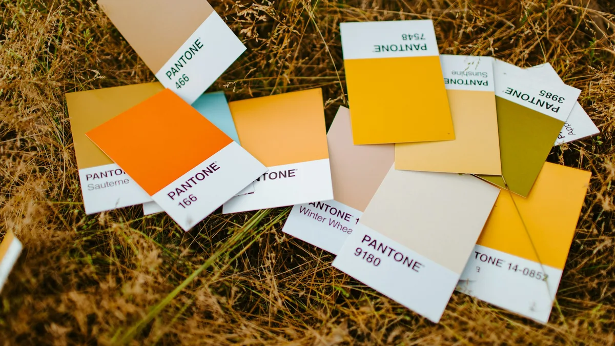 White and orange sticky notes arranged in a grid, representing organized design token categories