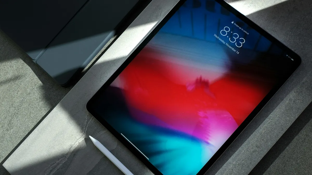iPad Pro with Apple Pencil on a stone desk in a clean design workspace