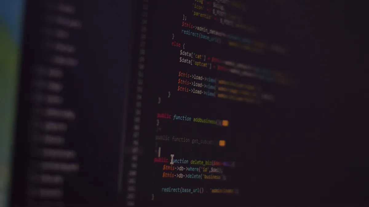 Source code in a text editor on a dark screen, photographed at an angle so the edges fall out of focus