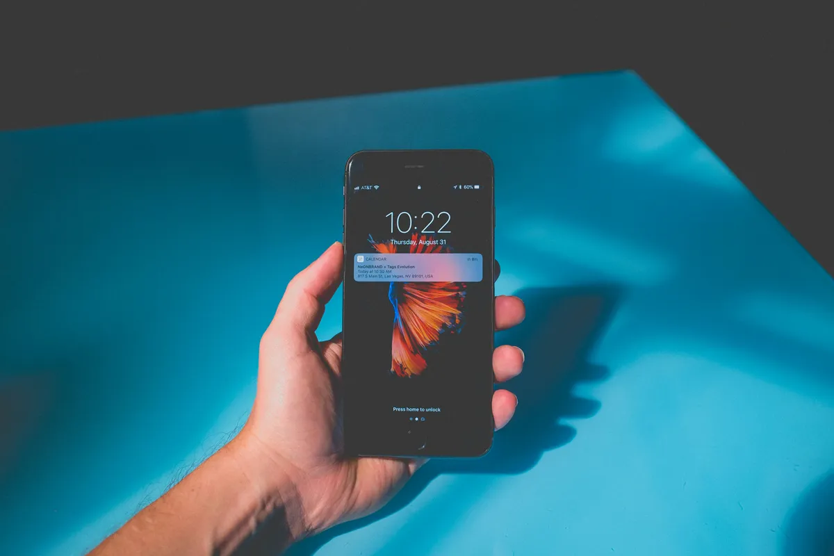A phone held in both hands with thumbs over the screen
