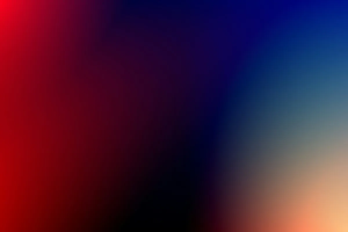 Red and blue light bleeding across a dark surface
