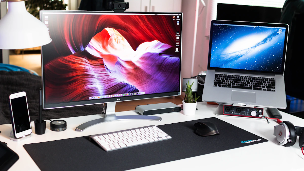 MacBook Pro beside an external monitor used for UI design work