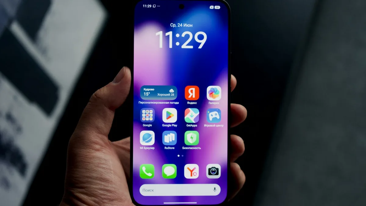 Hand holding a phone with colorful icons on a dark home screen
