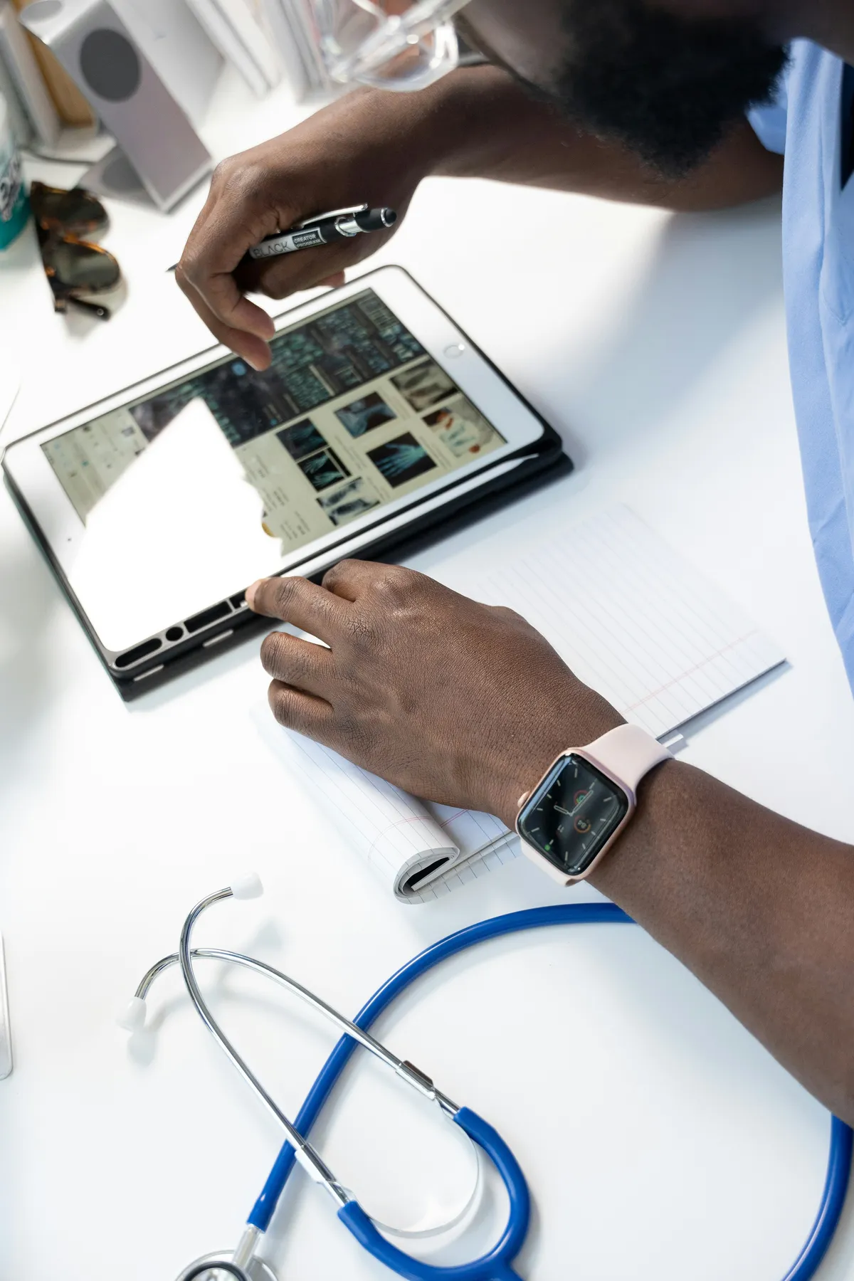 Healthcare professional using a tablet device to review data