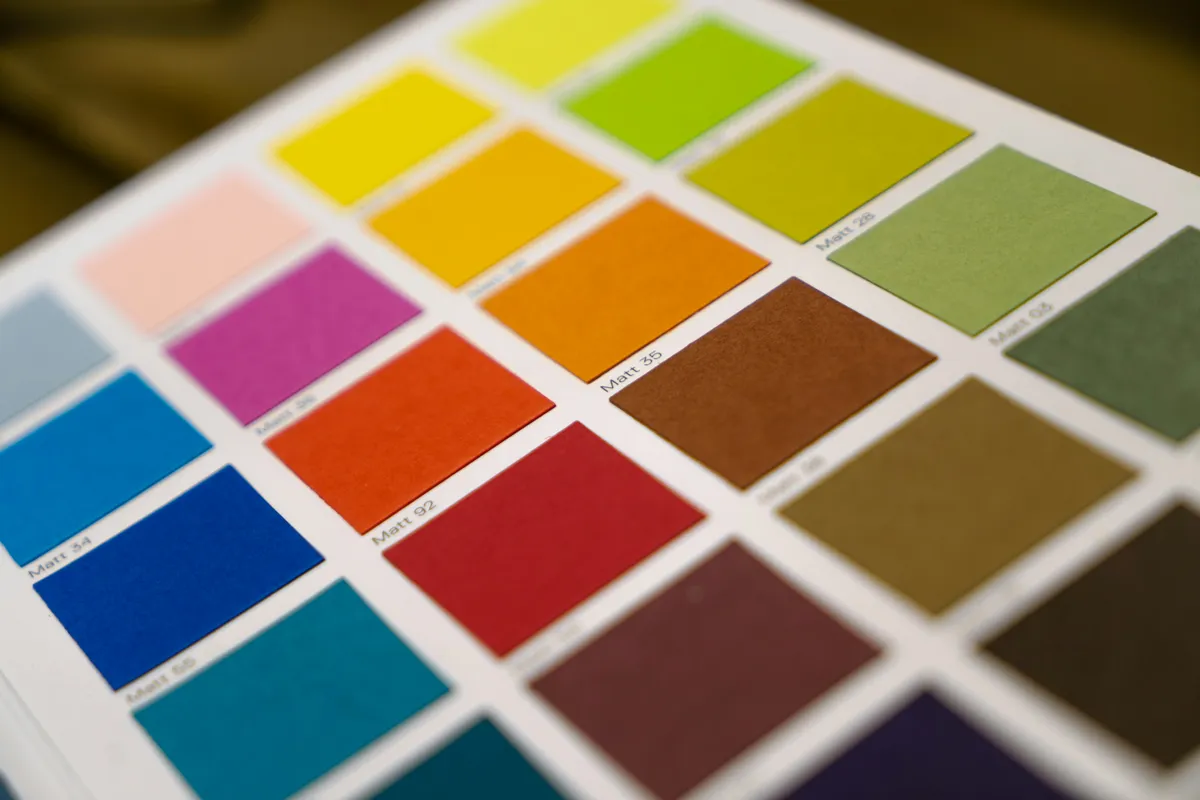 Yellow, orange and blue paper color samples in a matte finish
