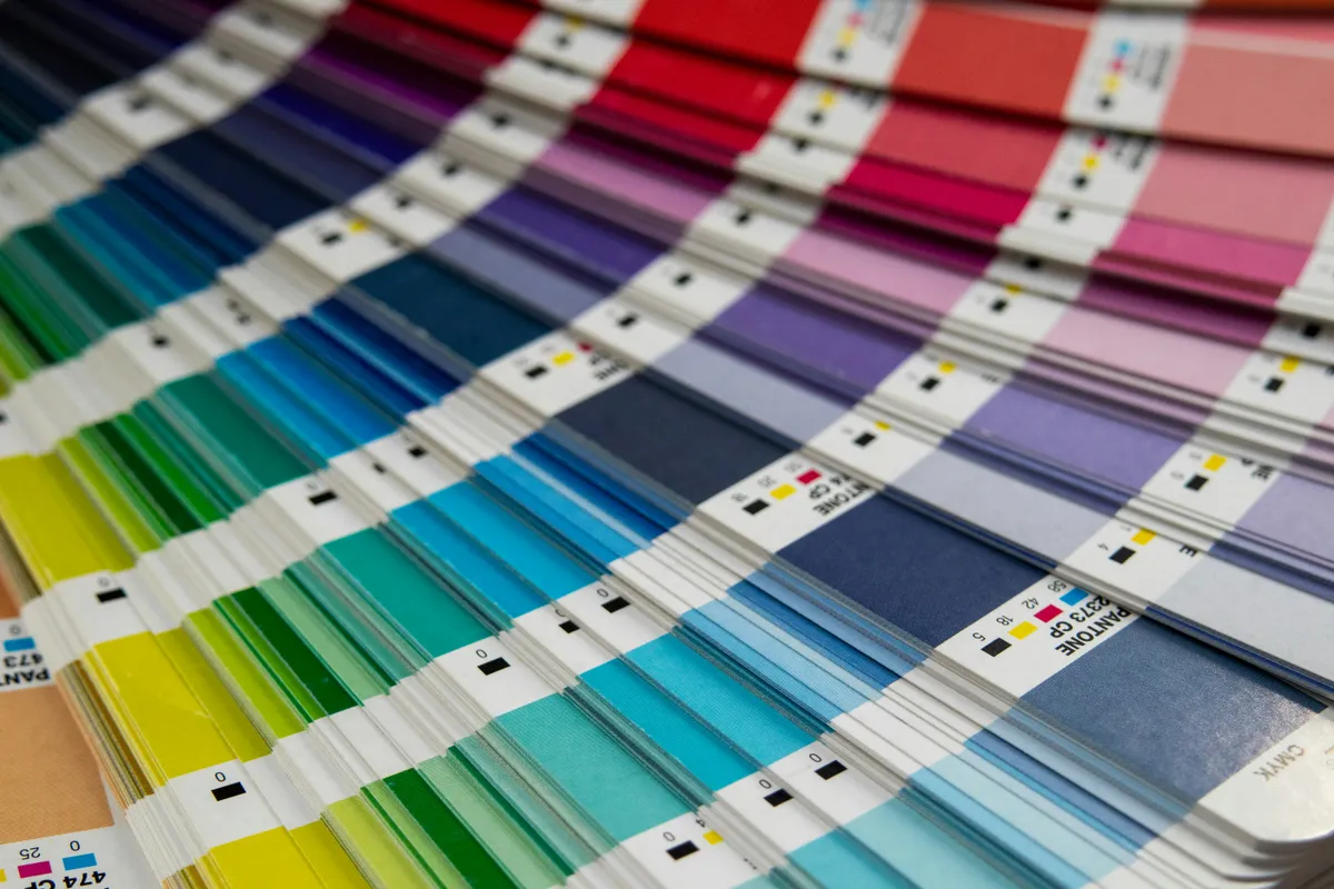A Pantone color palette spread out across a table