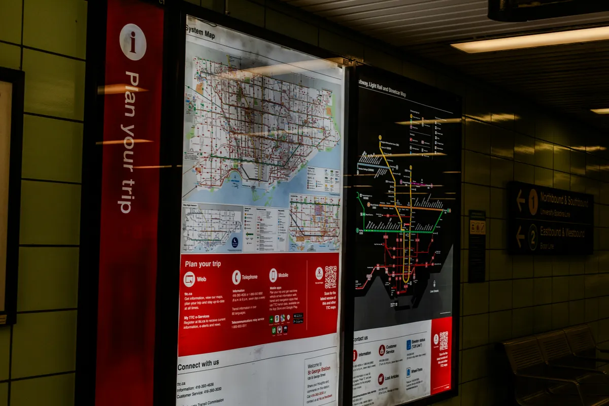 Illuminated transit maps under a plan your trip sign