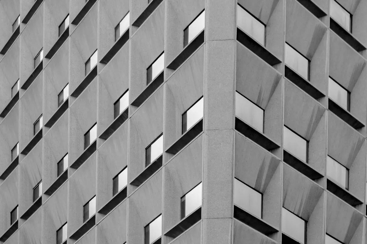 A building facade repeating one window unit across its whole face