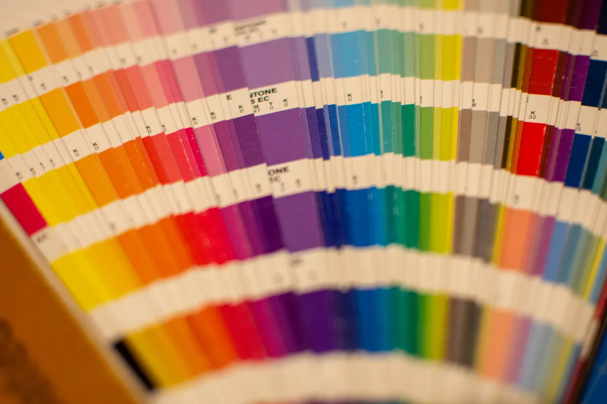 A close-up of a pan of colour samples mixed by hand