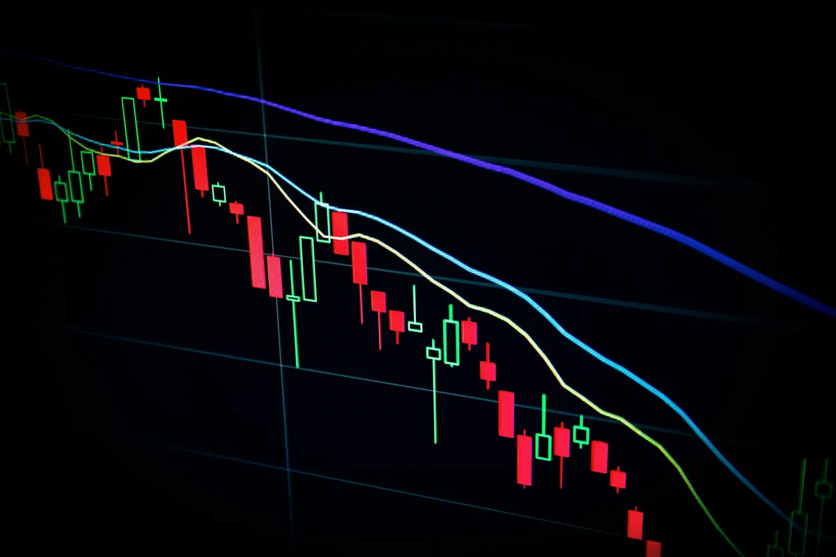 Stock market candlestick chart displayed on a dark screen, representing real-time price data in a fintech dashboard