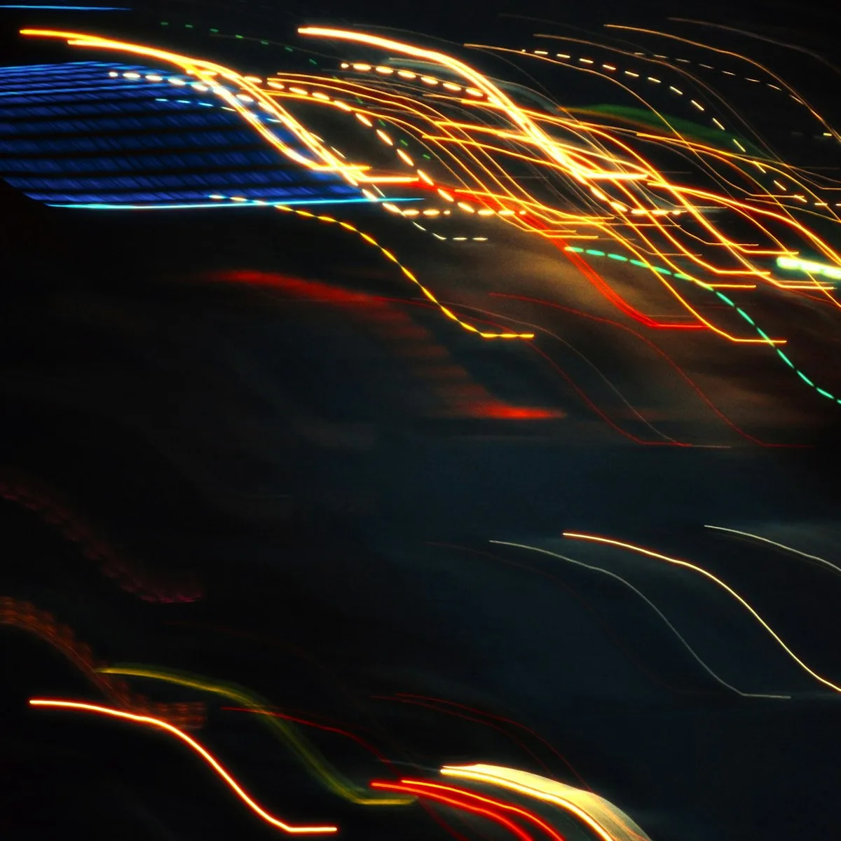 Abstract light trails swirling across a dark background suggesting animated motion