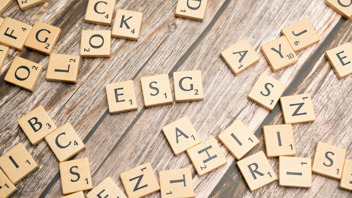 Scrabble letter tiles arranged on a wooden surface, representing individual letters that can be composed and animated