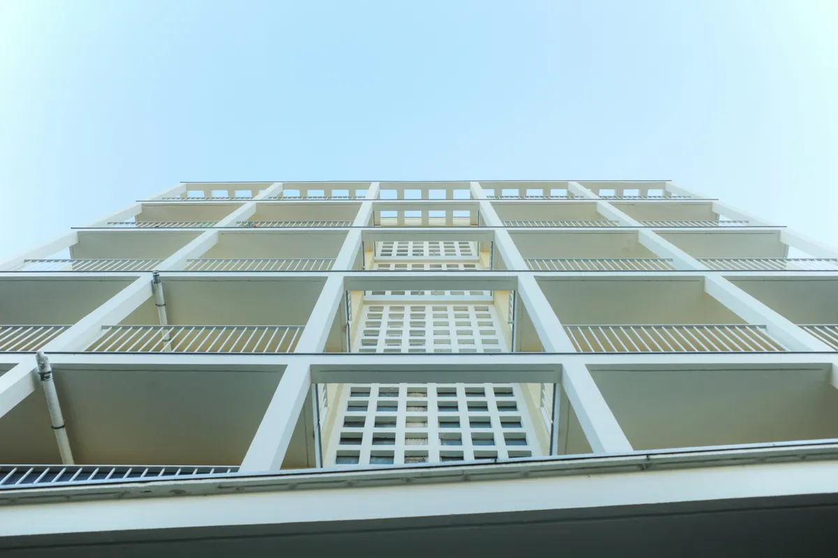 Geometric balconies stacked one above another against the sky