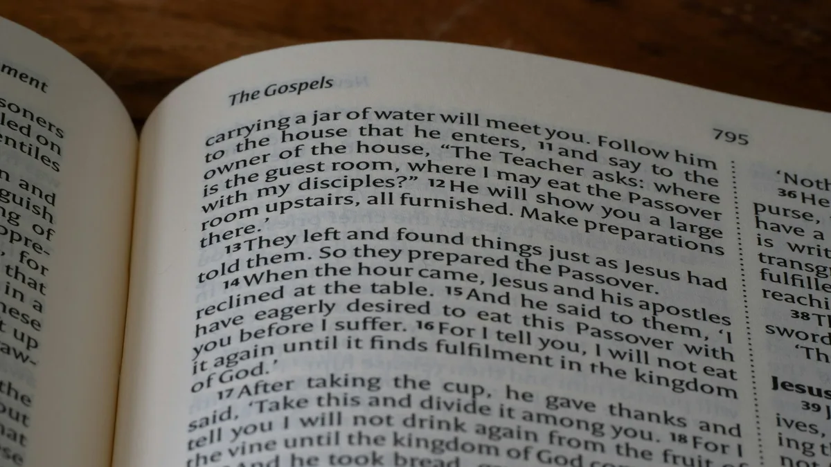 Open book with a pen resting on the page, showing printed text and margins