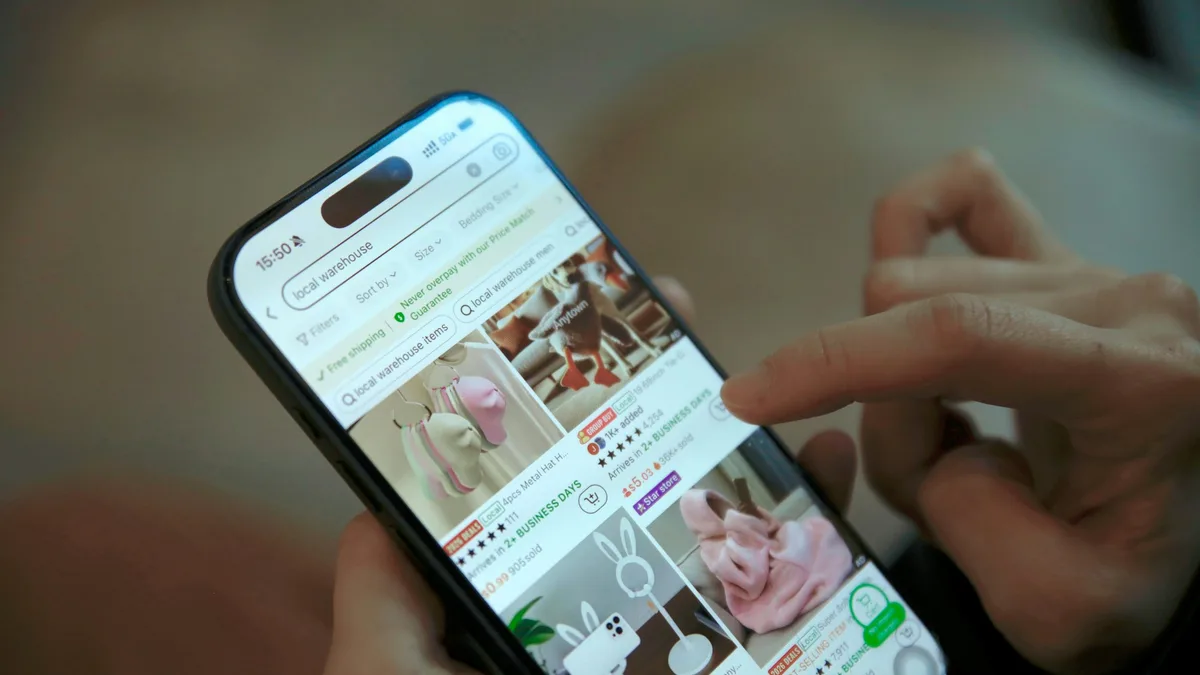 Person scrolling through a shopping app on a smartphone screen