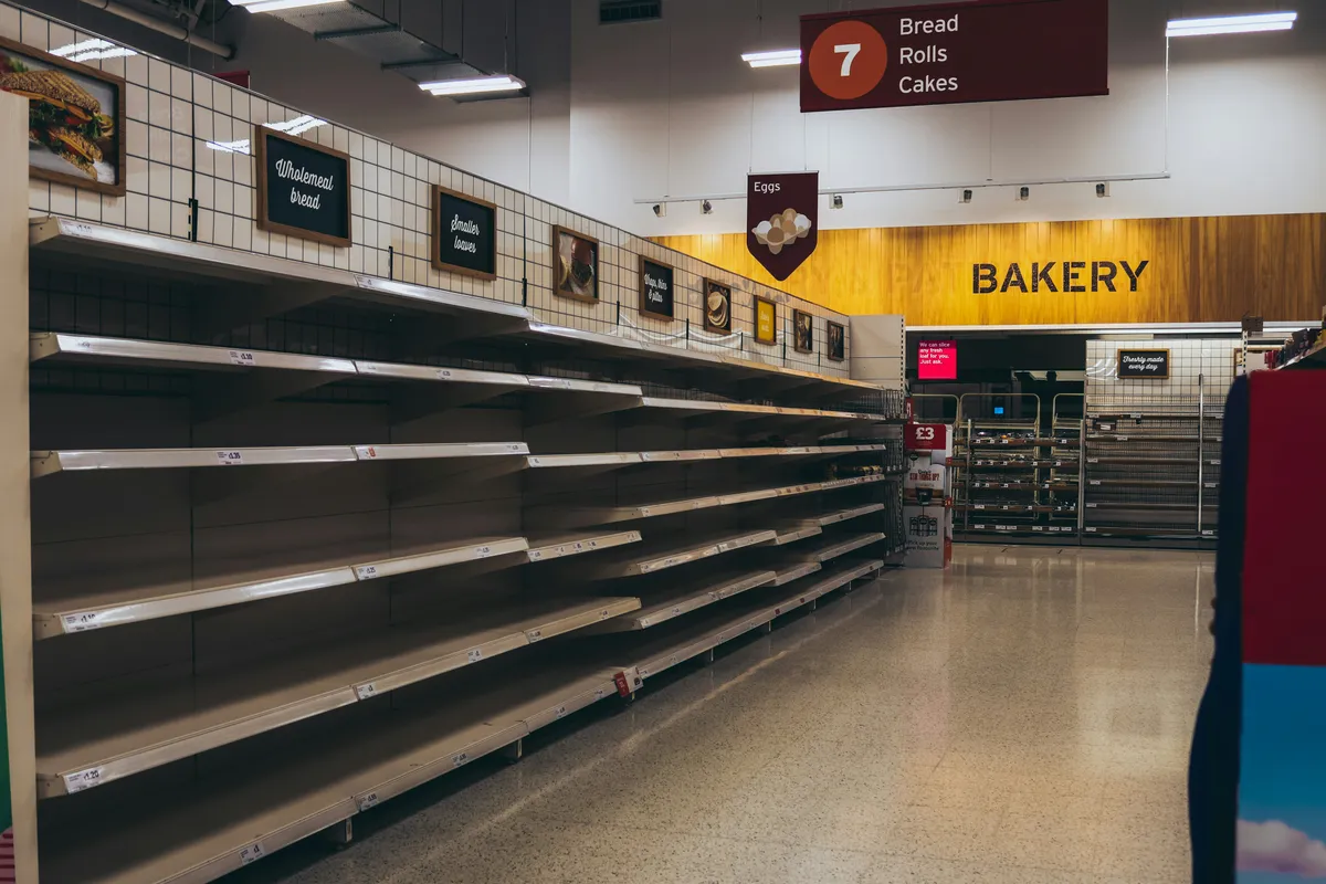 A bare wooden shelf with everything already taken off it