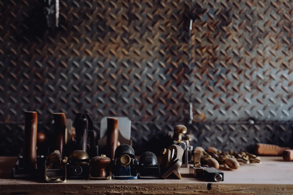 A workbench covered in a jumble of different tools