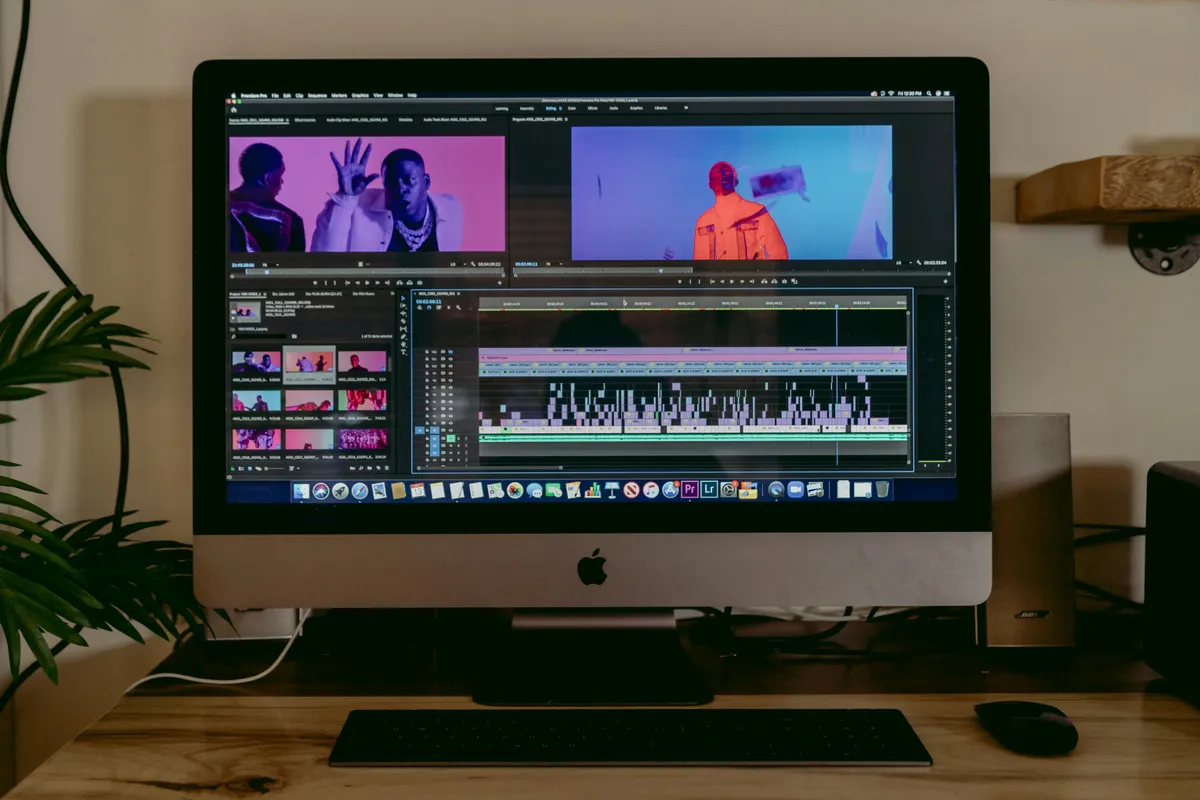 An iMac running an editing suite in a dim room