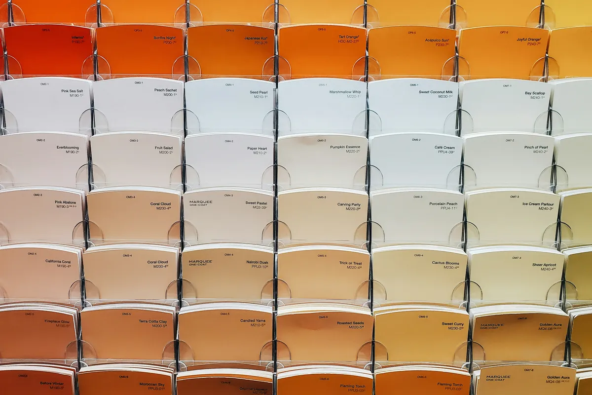 The same moulded chair repeated in white and in orange