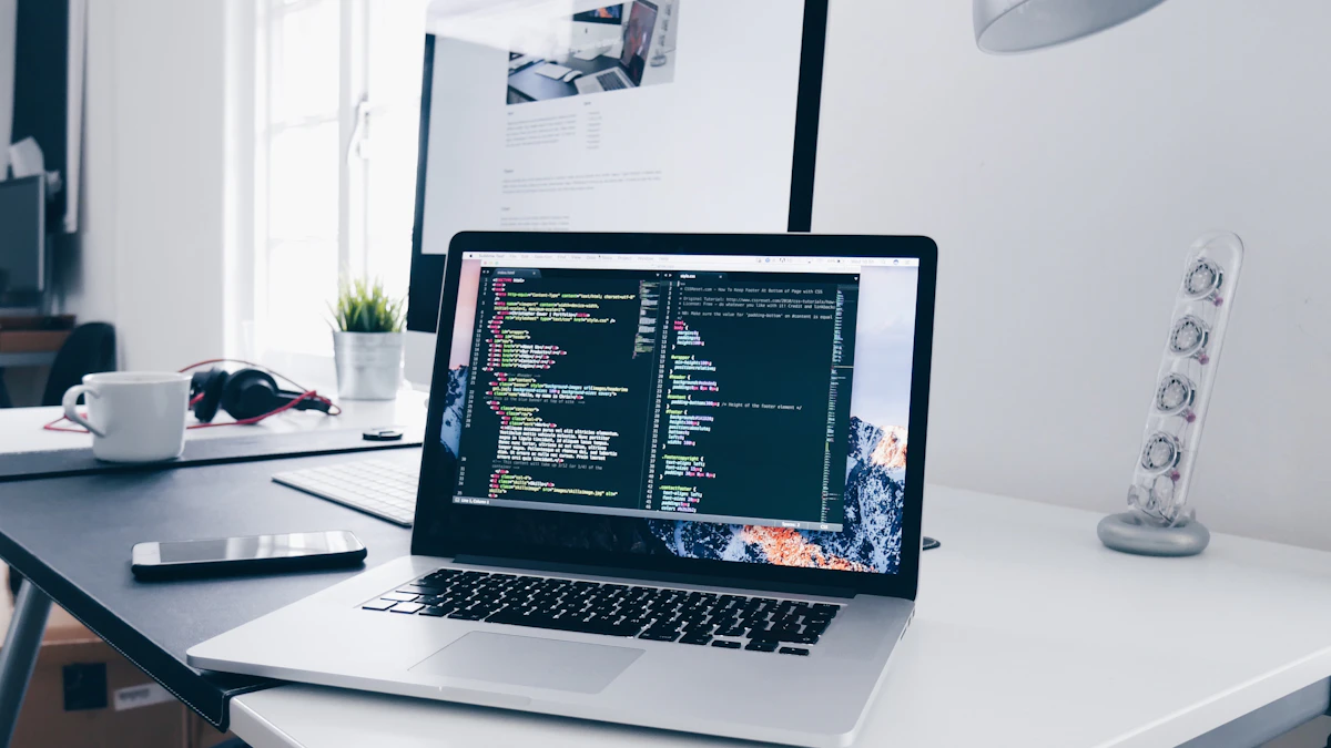 MacBook running code and design software on a busy work desk