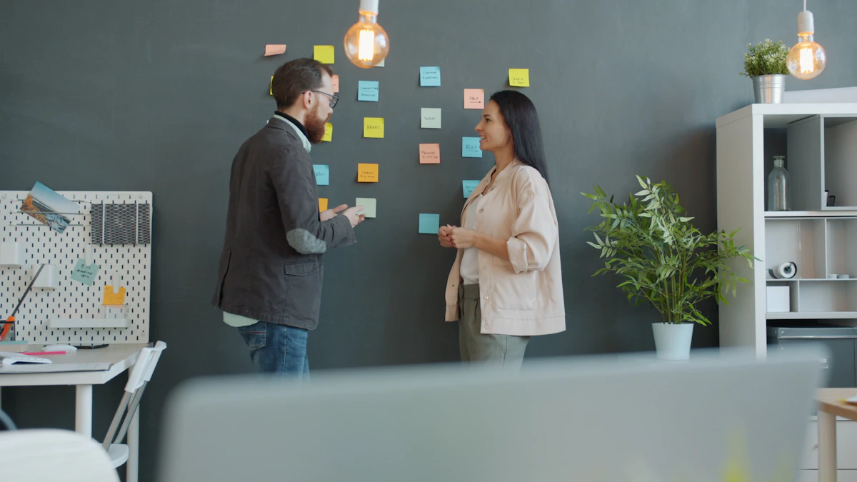 Two designers mapping a user flow with colorful sticky notes on a wall before prototyping