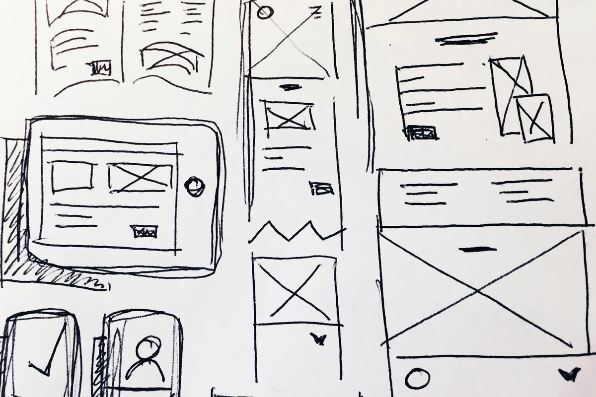 Hand-drawn wireframe frames sketched in black ink showing UI layout blocks