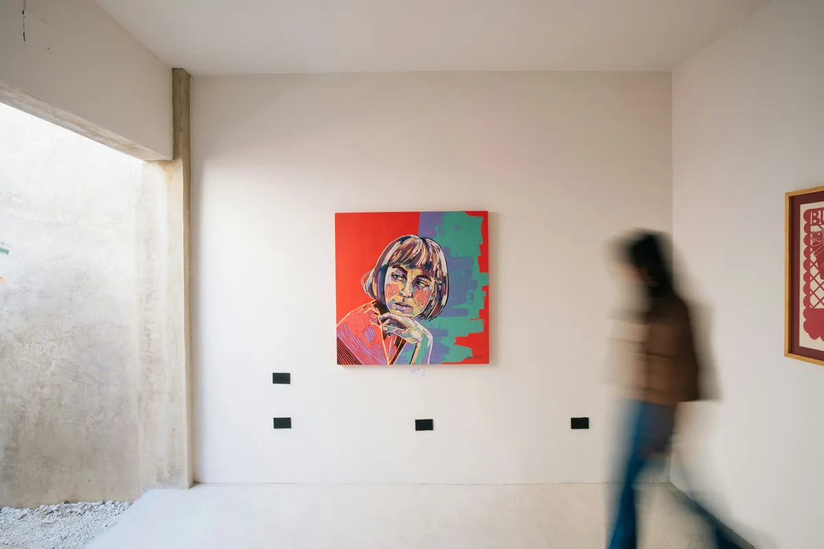 A single painting hung by itself on a white wall