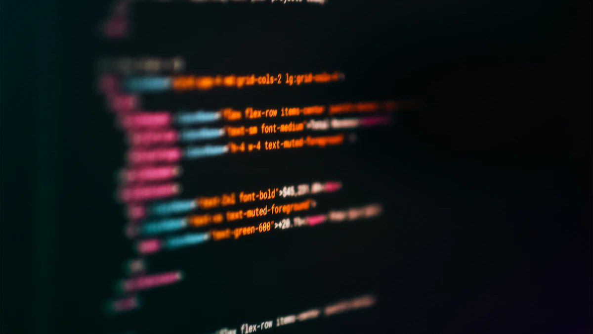 Computer monitor displaying colorful syntax-highlighted code in a dark editor