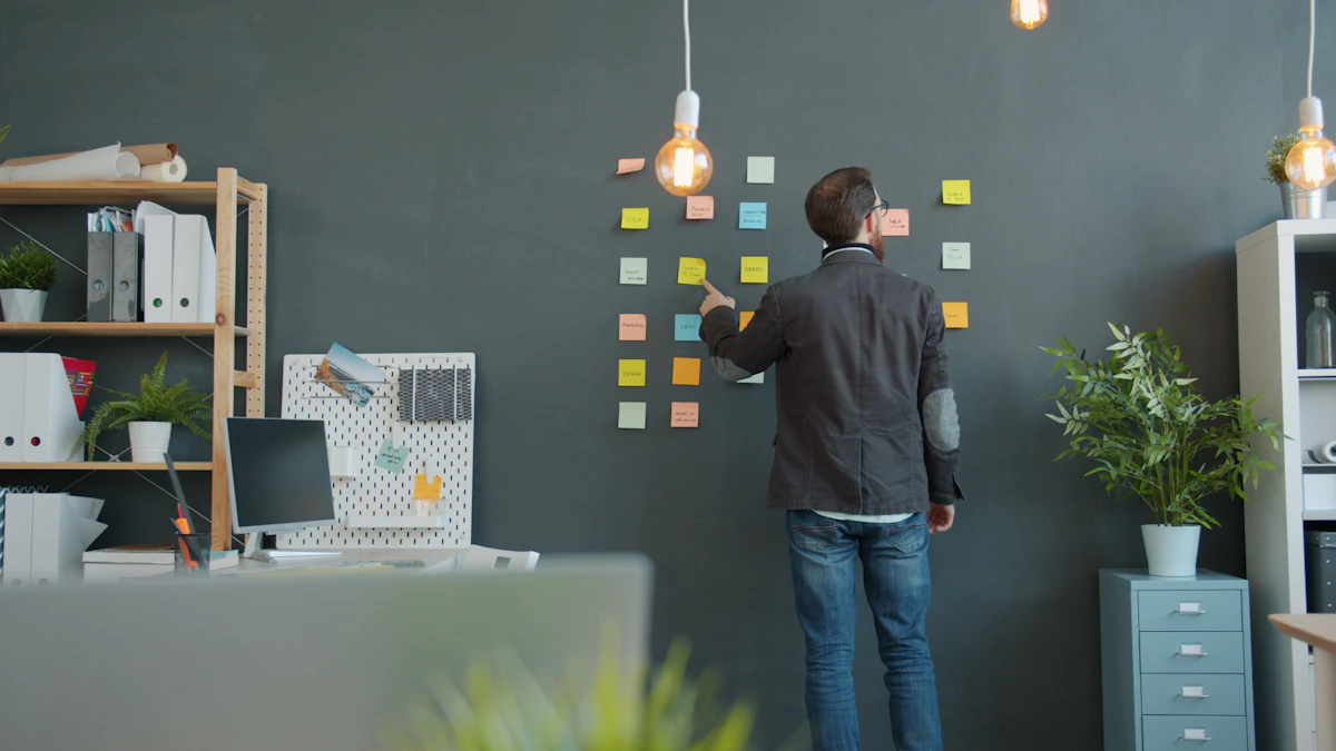 Person mapping a workflow across a sticky-note wall in an office