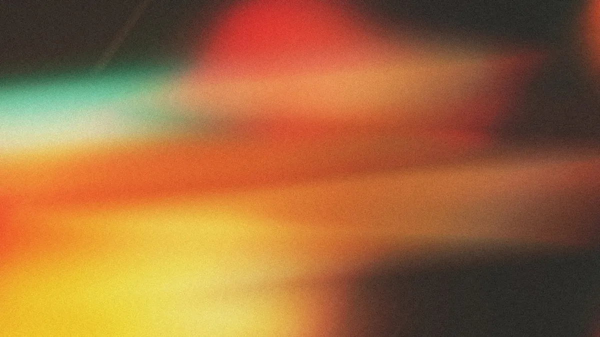 Warm abstract color gradient with soft bokeh illustrating color and contrast choices in motion
