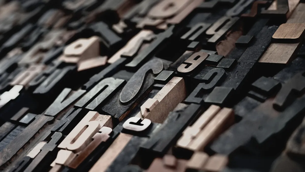 Wooden letterpress type blocks with whitespace demonstrating spacing and alignment